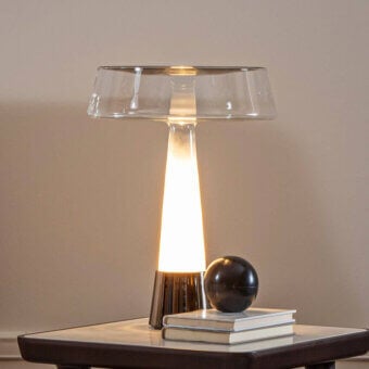 Superior Italamp Teco table lamp with conical glass and light gold finished metal base exhibiting warm amber tones