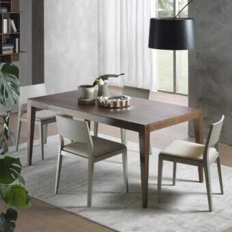Distinguished Pacini & Cappellini Dominique table crafted with solid ash wood and veneered ash in a dark brown finish exhibiting visible wood grain