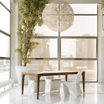 Elegant Pacini & Cappellini Fashion table crafted in wood veneered ash with a medium brown finish and subtly curved legs