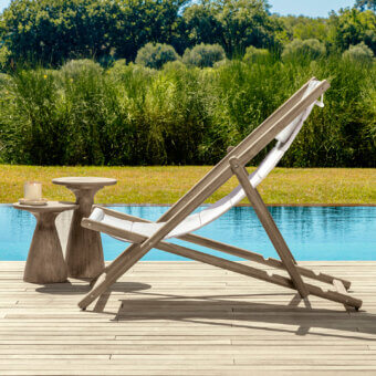 Timeless Talenti Dolcevita Wood deck chair with stained mid-tone brown teak wood frame and crisp white textile seat