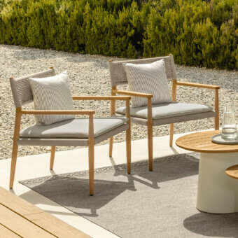 Distinguished Talenti Dolcevita Wood lounge chair with light wood frame and grayish-beige woven strings complemented by gray striped cushions