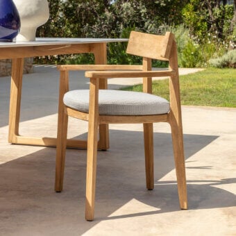 Sophisticated Talenti Ever armchair with light wood structure and light gray textured seat cushion in smooth matte finish