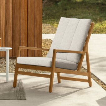 Superior Talenti Oliver lounge chair with teak frame and light gray cushions conveys refined comfort