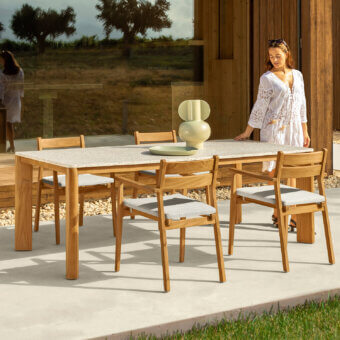 Superior Talenti Oliver table with grit tabletop and solid teak wood base in a warm matte finish