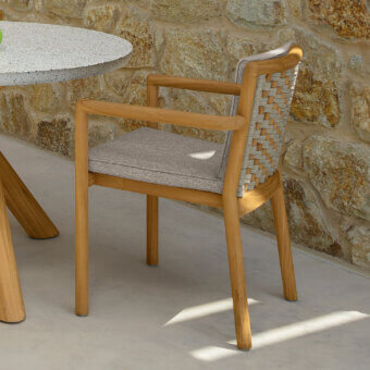 Superior Talenti Prichi armchair with woven ropes and a teak frame, complemented by a medium gray textile seat cushion