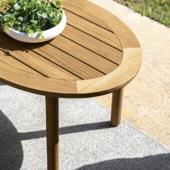 Superior Talenti Prichi coffee table crafted in medium-toned brown teak with cylindrical legs and a smooth finish
