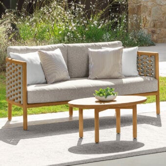Sophisticated Talenti Prichi sofa with teak wood frame woven in intricate rope and light gray cushions with striped beige pillows