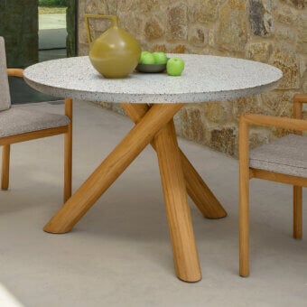 Superior Talenti Prichi table with a speckled light-toned tabletop and intersecting light-finished teak wood legs