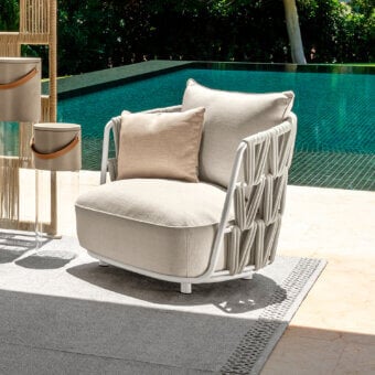 Distinctive Talenti Swipe lounge chair with light beige cushions and geometric woven padded rope detailing in a matte aluminum frame