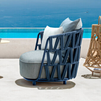 Distinguished Talenti Swipe lounge chair with blue synthetic frame and light gray cushions woven in textured rope detailing