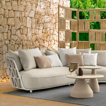 Sophisticated Talenti Swipe sofa exhibits lightness with soft light beige cushions and a dynamic tan rope weave aluminum backrest