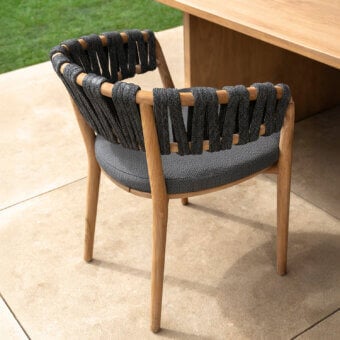 Distinguished Talenti Venice armchair with dark gray upholstery, solid teak wood frame and woven gray rope detailing