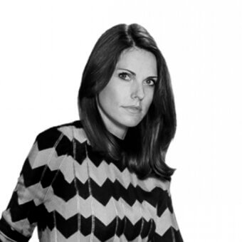 Woman in chevron knit sweater, black and white portrait, shoulder-length bob, neutral expression, white background, studio lighting.