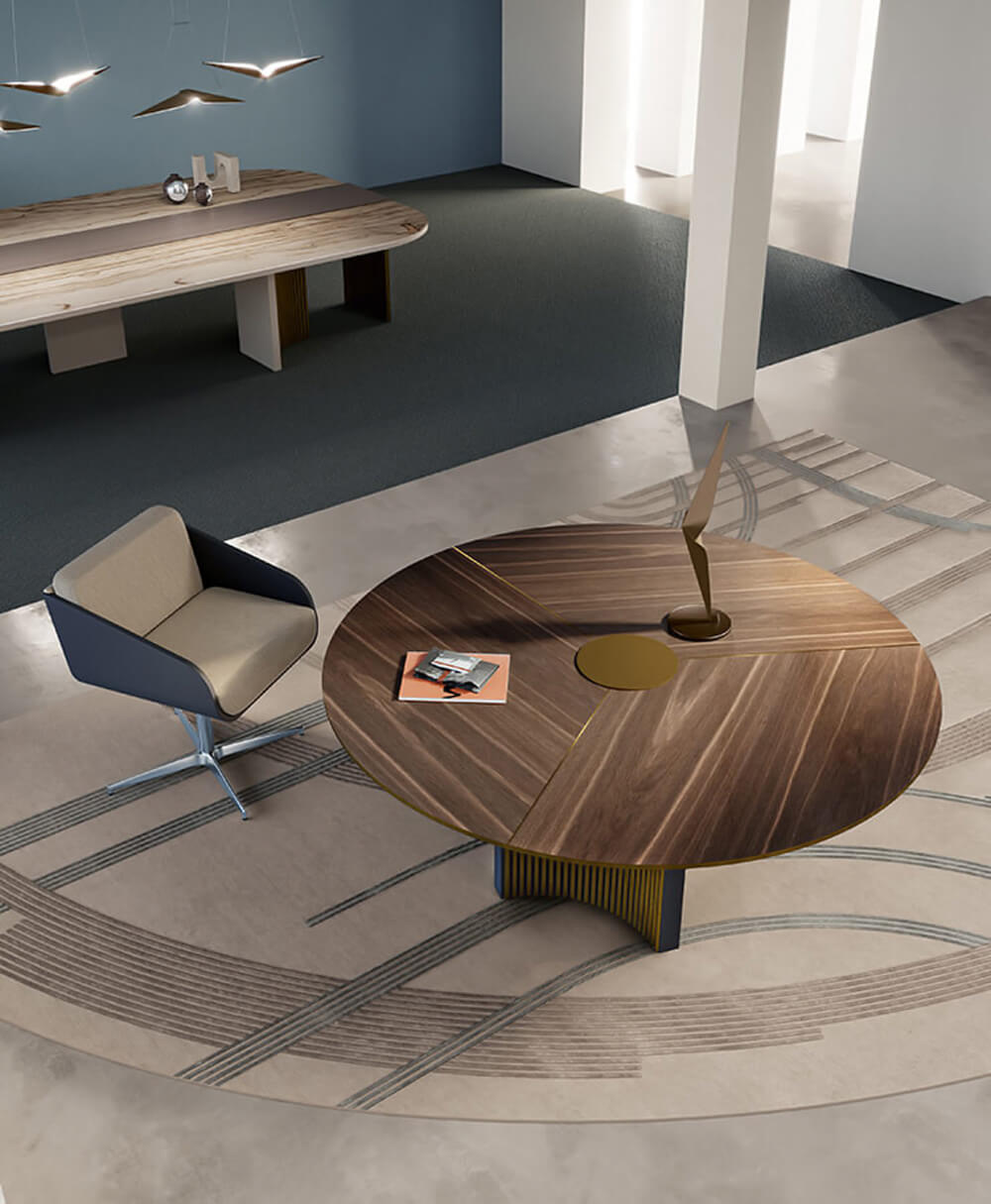 Plume coffee table, dark brown wood and brass, asymmetrical circular shape with gold metal band and dark blue base, modern interior setting.
