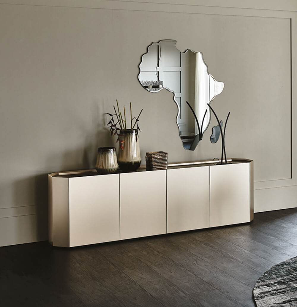 Cattelan Italia Chelsea sideboard, off-white matte finish, horizontal four-door cabinet with dark gray base, styled with vases and basket.