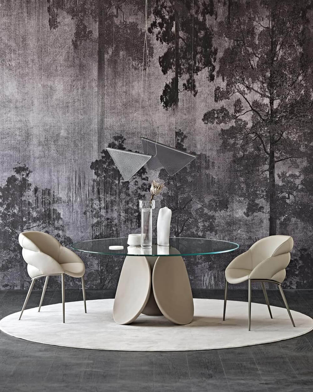 Cattelan Italia dining table with circular glass top and beige composite base, paired with light beige fabric chairs and stainless steel legs.