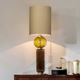 Elegant Italamp Matilda lamp with light gold metal and beige fabric lampshade, built with yellow blown glass and ribbed brown glass base