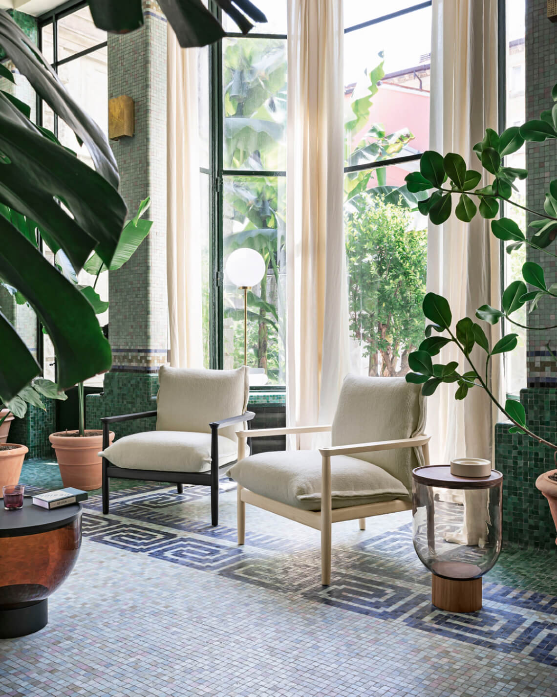 Miniforms Sergia lounge chairs, beige fabric, square backrests, set before window with blue mosaic floor and green tiled walls.