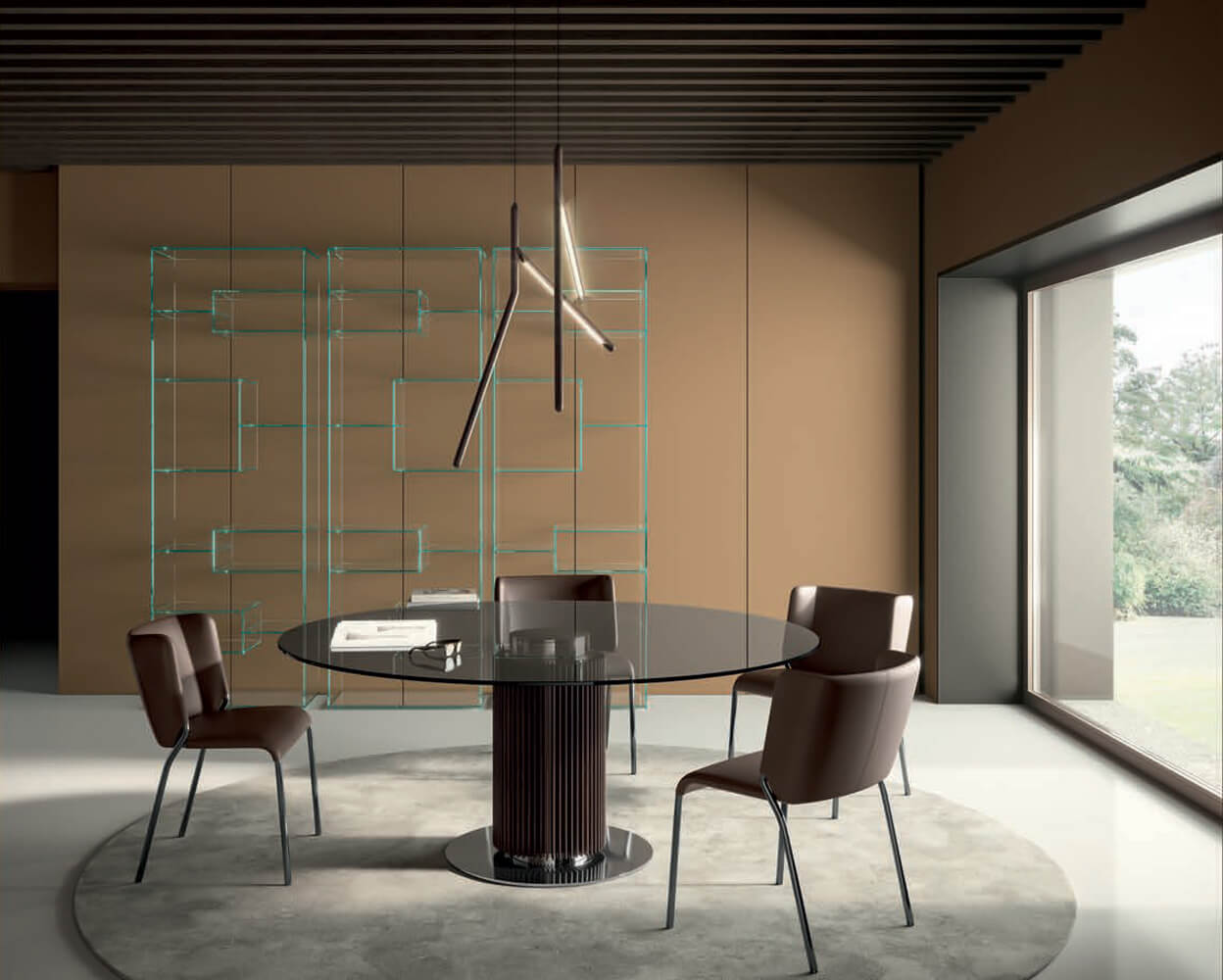 Glass dining table with fluted dark brown pedestal, surrounded by brown leather chairs on a light gray rug in a modern dining room.