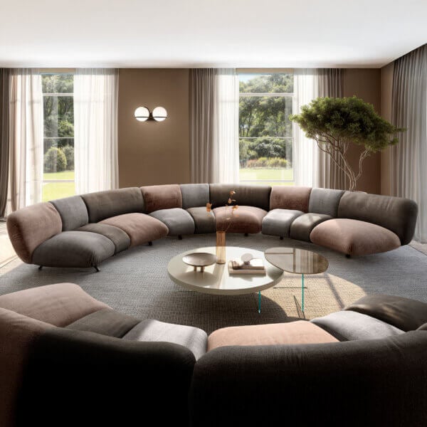 Modular sofa in gray, brown, and beige fabric curves around a glass coffee table in a digitally rendered living room interior.