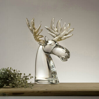 Glass reindeer sculpture by Duccio Di Segna, clear glass, detailed head with branching antlers on a wooden surface.