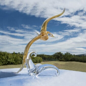 Glass seagull sculpture by Duccio Di Segna, amber and clear glass, stylized form with curved wings on a swirling base.