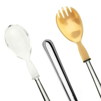 Salad serving set, translucent white, silver, gold; elongated cylindrical handles, polished metallic finish, four-tine fork, light gray background.