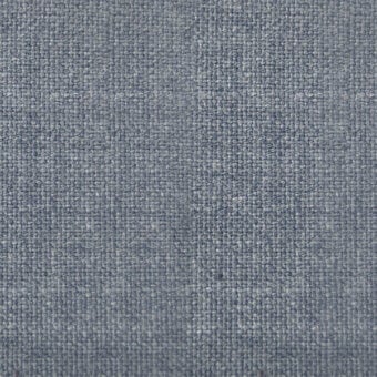 Cool blue woven fabric texture displays a dense twill weave with vertical and horizontal threads, creating a slightly mottled, durable appearance.