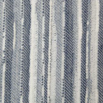 Ceruleo textile sample with vertical dark blue and white stripes, dense woven texture, and subtle twill variations in the blue sections.