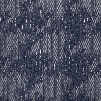 Navy floral textile with off-white embroidery, dense clustered motifs on a woven linen-like base, artisanal texture, sample marked "1096 notte wr".
