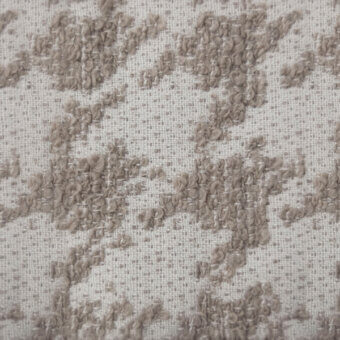 Fabric swatch with repeating floral pattern in oat and beige, featuring textured yarn tufts on a woven plain weave background.
