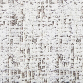 White woven fabric texture with gray and brown threads, displaying a speckled, nubby pattern and matte finish suitable for upholstery.