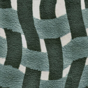 Textile pattern with repeating teal, gray-green, and off-white rectangles in a skewed, overlapping arrangement; looped pile texture suggests upholstery.