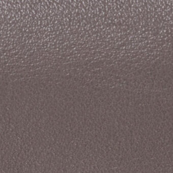 Mottled brownish-gray texture with granular surface, displaying fine lines and pores in a smooth, dense material with a matte finish.