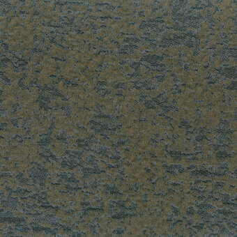 Textured fabric sample, olive green and teal mottled pattern, distressed finish, uneven color distribution, diffused lighting, label detail.