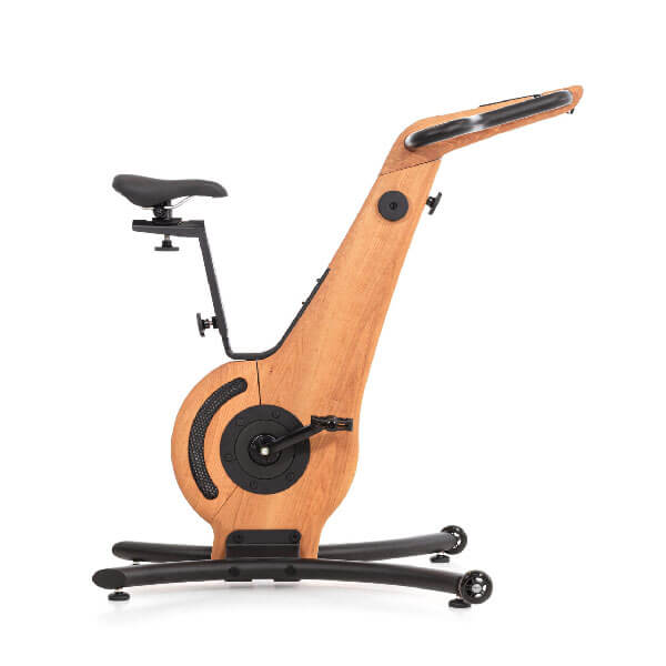 Exercise bike with light wood frame and black metal base, featuring curved handlebars, adjustable seat, and caster wheels.