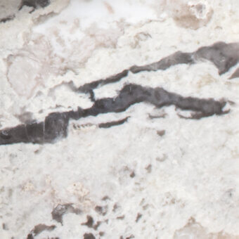 White marble texture with dense, horizontal dark gray veining and a granular matte finish, displaying subtle tonal variations.