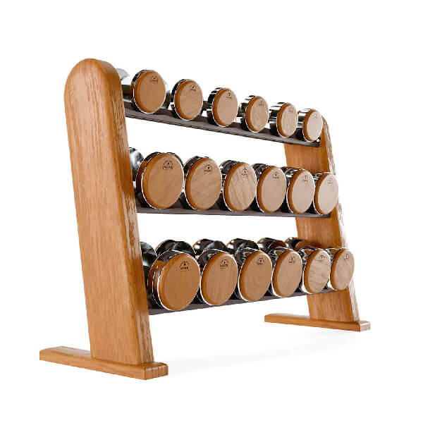 Dumbbell rack made of light wood displays round, brown and silver dumbbells arranged by weight on three tiers for strength training.