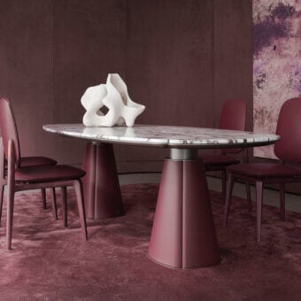 Elegant Giorgetti Floria table with polished marble top exhibiting grey veining and reddish-purple matte leather base crafted with milled corners