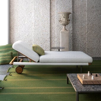 Superior Giorgetti Moorea lounger with pewter painter stainless steel frame and off-white Open-Air fabric upholstery accented with olive green