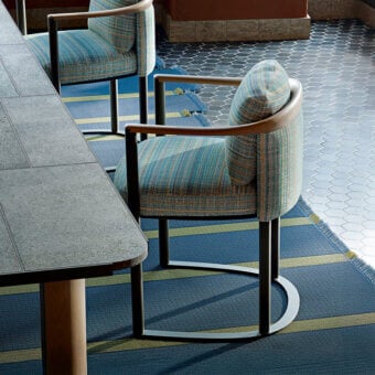 Exceptional Giorgetti Moorea armchair with pewter painted stainless steel frame and vibrant multi-colored striped fabric upholstery
