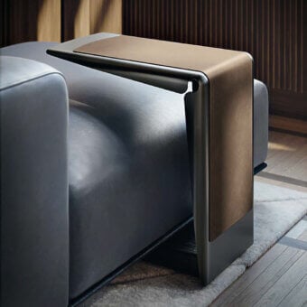 Elegant Giorgetti Ploto side table with a curved dark gray matte metal structure and warm medium-brown wooden base, built with a leather band