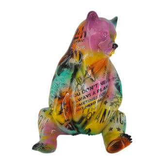Sculpture of seated bear by Juliarte, glossy multi-colored resin, swirling pink, yellow, green, blue hues with graffiti text details.