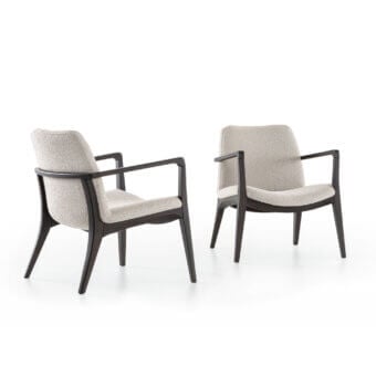 Ellen lounge chairs, off-white fabric upholstery, square backrests, dark brown angled wood legs, modern studio setting.