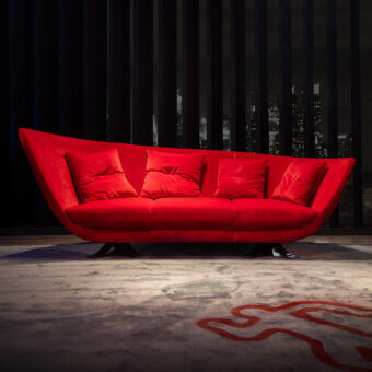 Captivating Joker Home Collection sofa with curved form, vibrant red velvet upholstery and a matte finish
