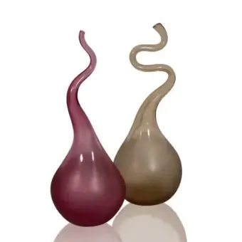 Murano glass vases, magenta and beige, with organic teardrop bodies and curved, spiraling necks on a white reflective surface.