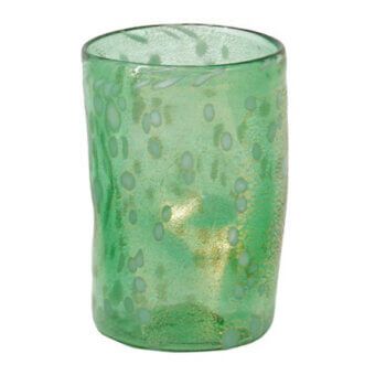 Green glass tumbler with gold inclusions, organic shape, textured surface, and uneven rim against a white backdrop.