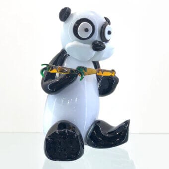 Glass panda sculpture, white with black markings, seated holding yellow-green bamboo, on textured black glass base, glossy finish.