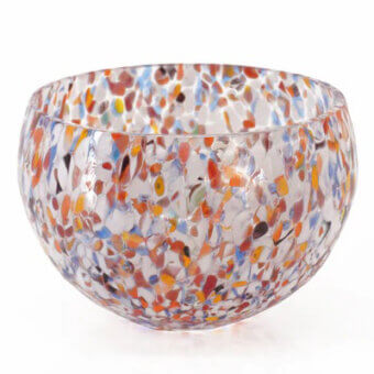 Glass bowl, spotted multicolor, round shape with mosaic glass pieces in orange, yellow, blue, red, and white, studio product shot.
