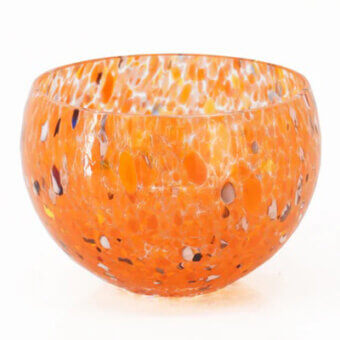 Orange glass bowl with speckled pattern, rounded shape, and flared rim displayed on a white background in studio lighting.
